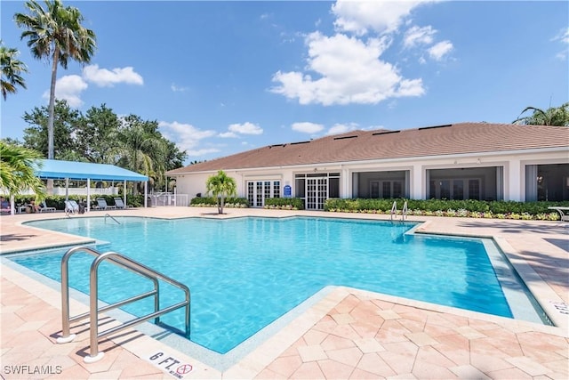 14696 Indigo Lakes Cir, Naples, FL 34119 - community pool with a patio area