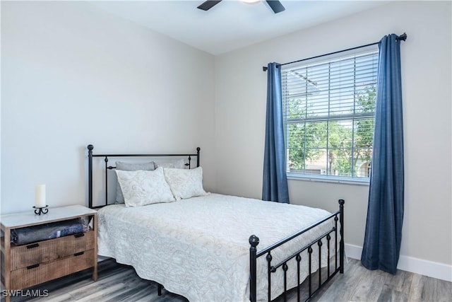 14696 Indigo Lakes Cir, Naples, FL 34119 - bedroom with wood finished floors, a ceiling fan, and baseboards