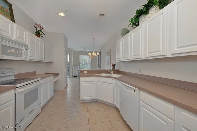 2165 Arielle Dr Unit 1605, Naples, FL 34109 - kitchen with an inviting chandelier, white cabinetry, a sink, and white appliances