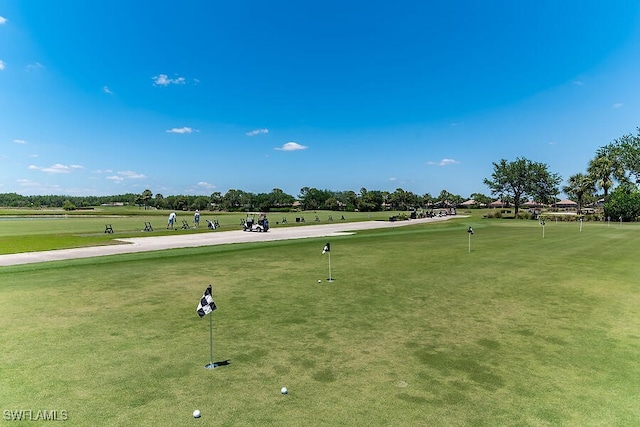 surrounding community featuring view of golf course