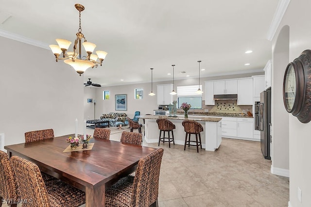dining room with arched walkways, recessed lighting, a notable chandelier, and crown molding