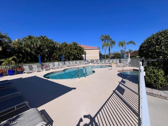 pool featuring a patio area and fence