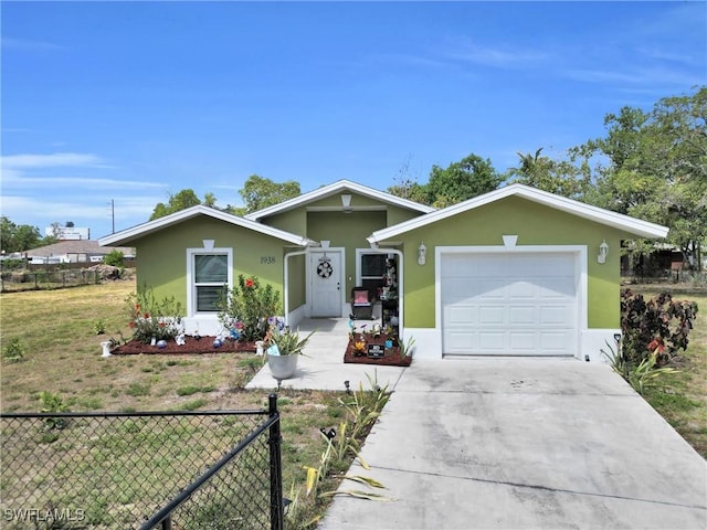 1938 Lillie St, Fort Myers, FL 33916 - ranch-style home with stucco siding, concrete driveway, and a garage