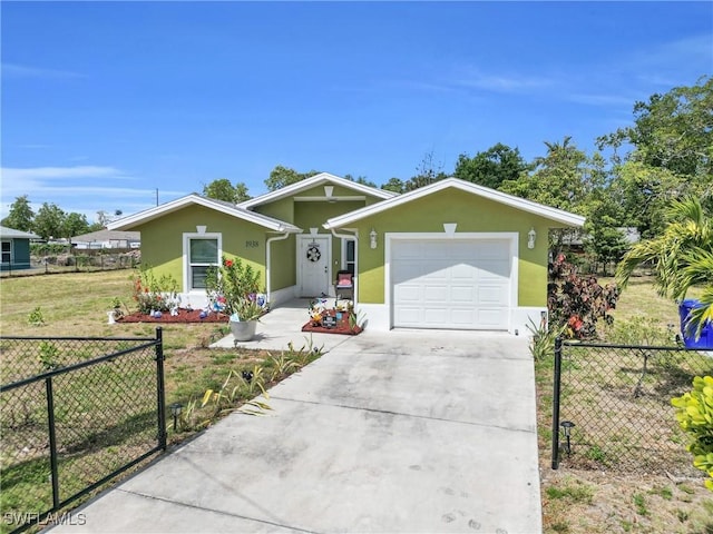 1938 Lillie St, Fort Myers, FL 33916 - view of front of home featuring concrete driveway, a garage, and stucco siding