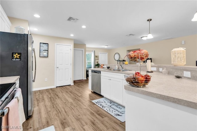 1938 Lillie St, Fort Myers, FL 33916 - kitchen featuring stainless steel appliances, a sink, light wood-type flooring, white cabinets, and recessed lighting