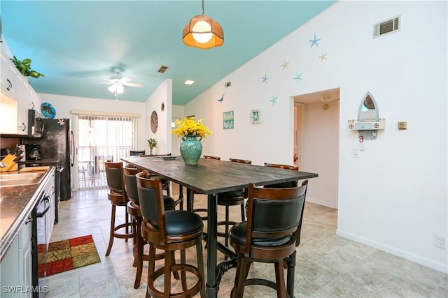 4030 Northlight Dr, Naples, FL 34112 - dining space featuring baseboards, vaulted ceiling, visible vents, and a ceiling fan