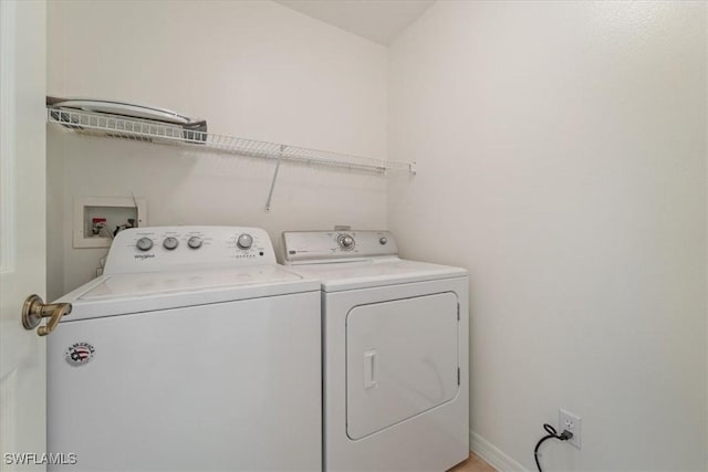6560 Huntington Lakes Cir Unit 102, Naples, FL 34119 - laundry area featuring baseboards, washing machine and dryer, and laundry area
