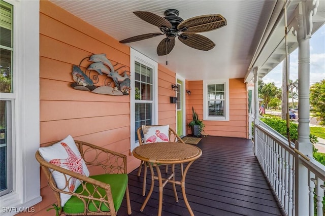 wooden deck with a porch and ceiling fan