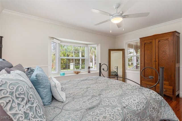bedroom with wood finished floors, ceiling fan, and crown molding