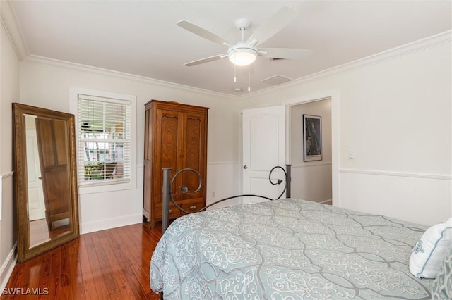 bedroom featuring hardwood / wood-style flooring, ceiling fan, and ornamental molding