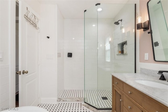 bathroom featuring vanity, tile patterned floors, and a stall shower