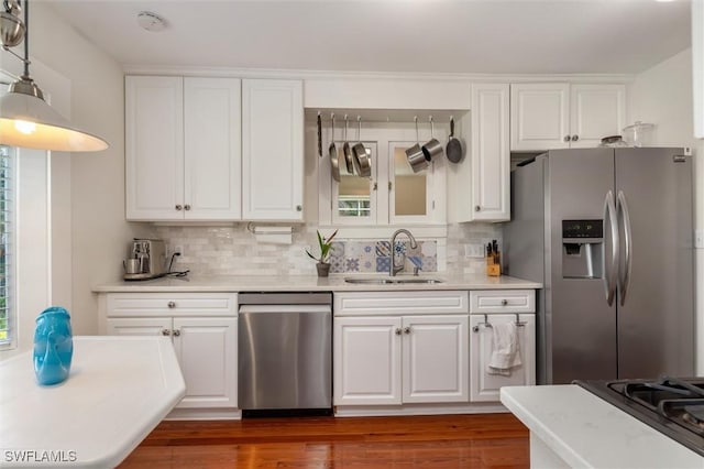 kitchen featuring white cabinets, tasteful backsplash, appliances with stainless steel finishes, and a sink