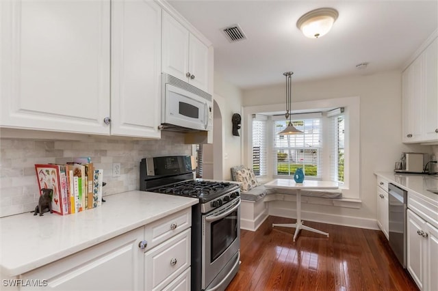 kitchen with white cabinetry, appliances with stainless steel finishes, and visible vents