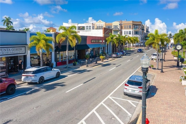 view of road featuring sidewalks, curbs, and street lighting