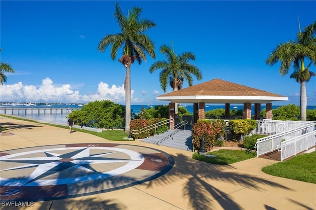 view of property's community featuring a gazebo, a water view, and fence