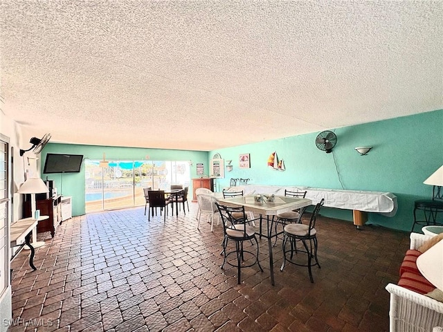 dining room featuring a textured ceiling