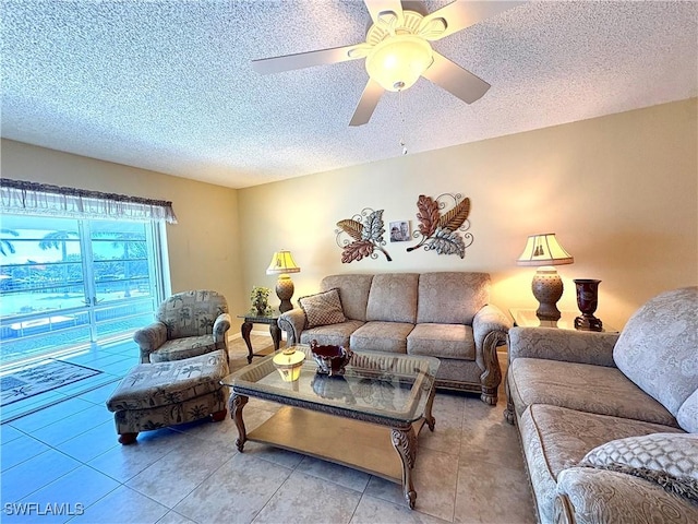 tiled living area with a textured ceiling and ceiling fan