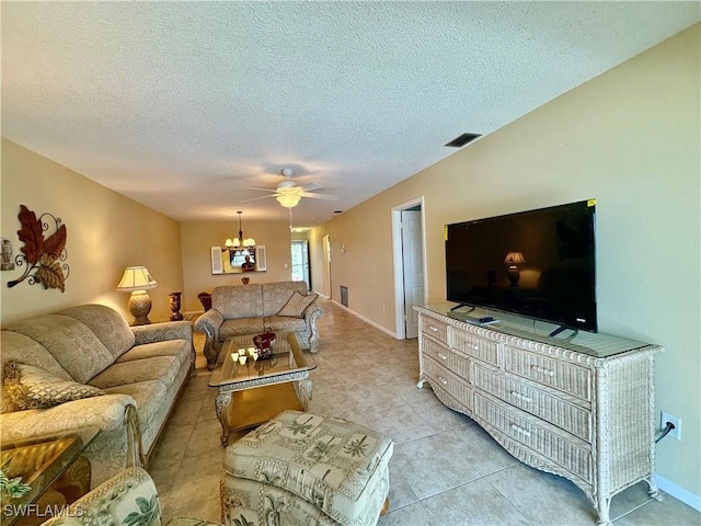 living room with baseboards, light tile patterned floors, a textured ceiling, visible vents, and ceiling fan with notable chandelier