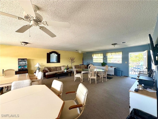 carpeted dining space featuring ceiling fan and a textured ceiling