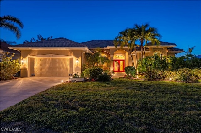 211 Lido Dr, Punta Gorda, FL 33950 - view of front of home with concrete driveway, stucco siding, french doors, a front yard, and a garage