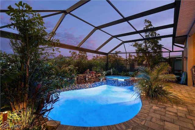 211 Lido Dr, Punta Gorda, FL 33950 - pool at dusk with a pool with connected hot tub, a patio area, and a lanai