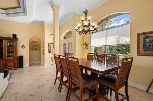 211 Lido Dr, Punta Gorda, FL 33950 - dining space featuring baseboards, arched walkways, ornamental molding, a chandelier, and light tile patterned flooring