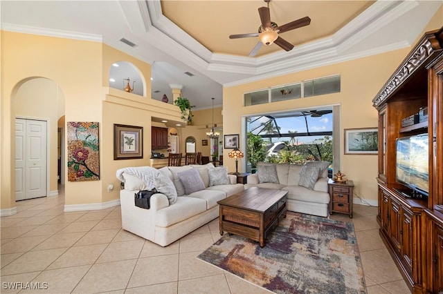 211 Lido Dr, Punta Gorda, FL 33950 - living area featuring light tile patterned floors, arched walkways, a high ceiling, ceiling fan, and crown molding