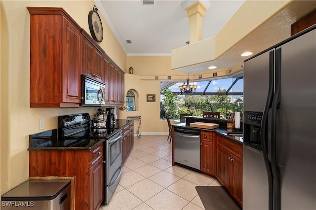 211 Lido Dr, Punta Gorda, FL 33950 - kitchen with light tile patterned floors, an inviting chandelier, ornamental molding, visible vents, and appliances with stainless steel finishes
