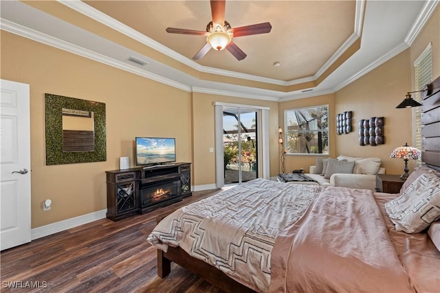 211 Lido Dr, Punta Gorda, FL 33950 - bedroom featuring access to outside, dark wood finished floors, a tray ceiling, a glass covered fireplace, and baseboards