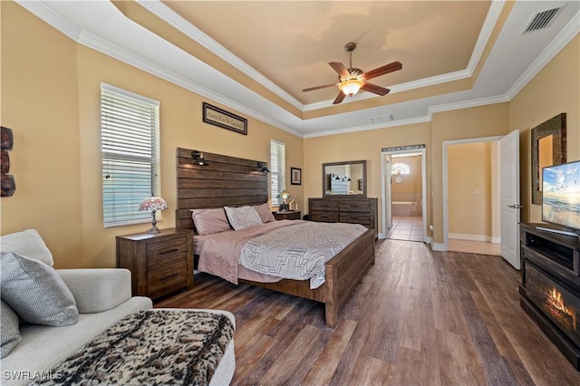 211 Lido Dr, Punta Gorda, FL 33950 - bedroom featuring visible vents, baseboards, a raised ceiling, dark wood-style flooring, and crown molding