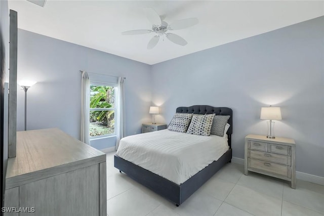bedroom featuring light tile patterned floors, ceiling fan, and baseboards