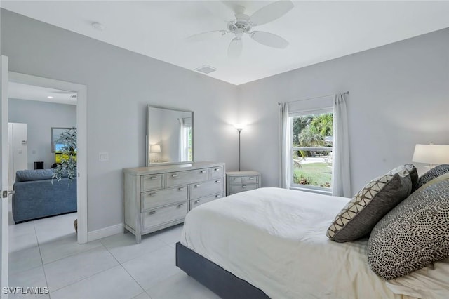 bedroom with visible vents, baseboards, a ceiling fan, and light tile patterned floors