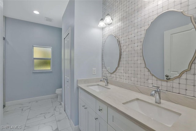bathroom with a sink, visible vents, baseboards, and toilet