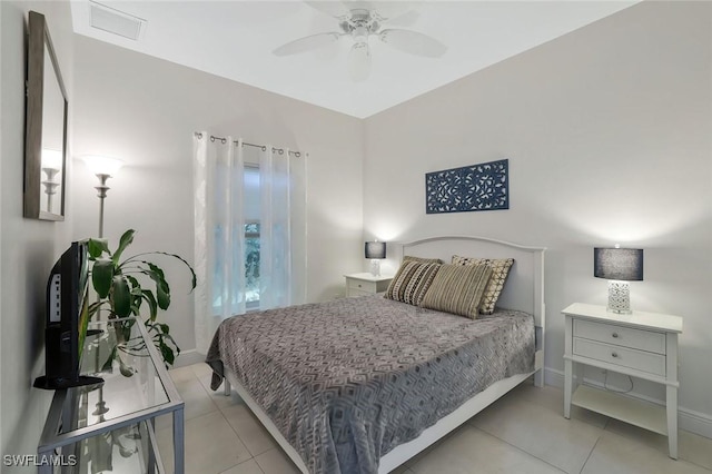 tiled bedroom with baseboards and a ceiling fan