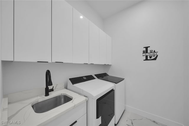 laundry room featuring independent washer and dryer, marble finish floor, a sink, baseboards, and cabinet space
