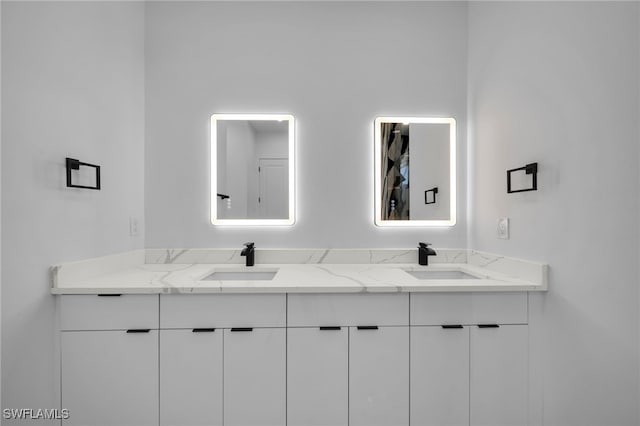 bathroom with a sink and double vanity