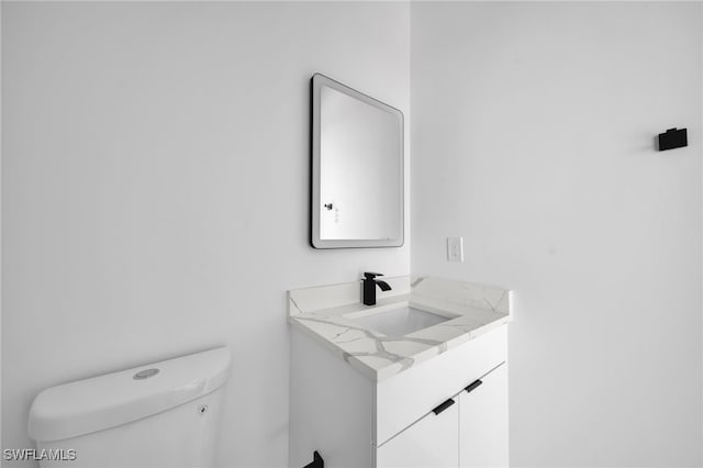 bathroom featuring toilet and vanity