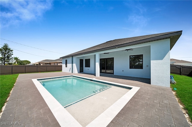 view of swimming pool with a fenced in pool, a patio, a ceiling fan, a fenced backyard, and a lawn