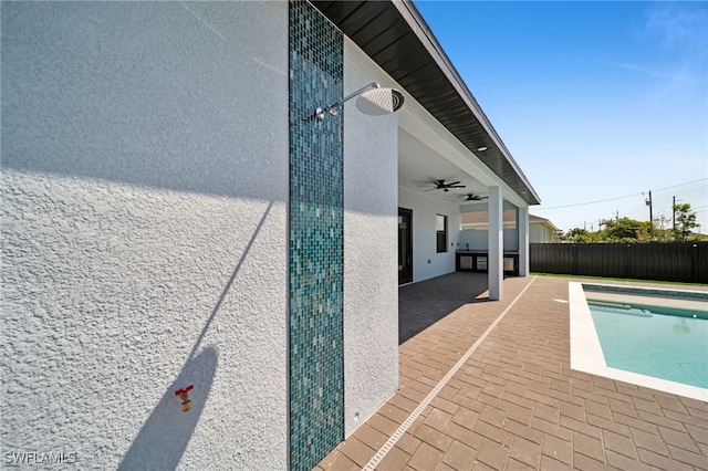 view of pool featuring a fenced in pool, ceiling fan, a fenced backyard, and a patio area