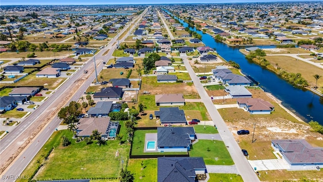 drone / aerial view with a water view and a residential view