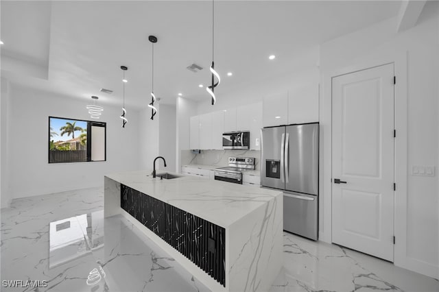 kitchen featuring modern cabinets, white cabinetry, recessed lighting, appliances with stainless steel finishes, and a sink