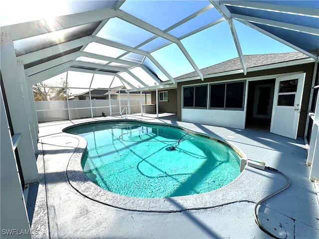 view of pool with a fenced in pool, a patio area, glass enclosure, and fence