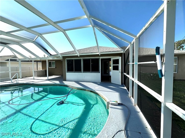 view of pool featuring a patio area, a fenced in pool, and glass enclosure