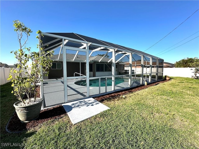 view of swimming pool featuring a yard, a fenced backyard, glass enclosure, a patio, and a fenced in pool