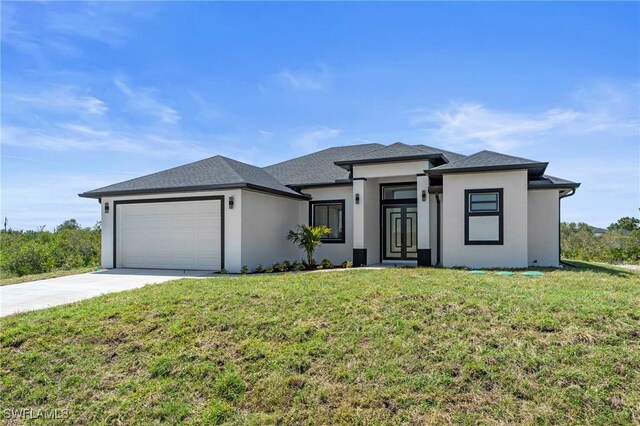 2705 68th St W, Lehigh Acres, FL 33971 - prairie-style house with concrete driveway, stucco siding, a front yard, and a garage