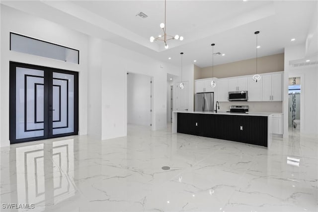 2705 68th St W, Lehigh Acres, FL 33971 - kitchen featuring a large island, a towering ceiling, stainless steel appliances, white cabinetry, and recessed lighting