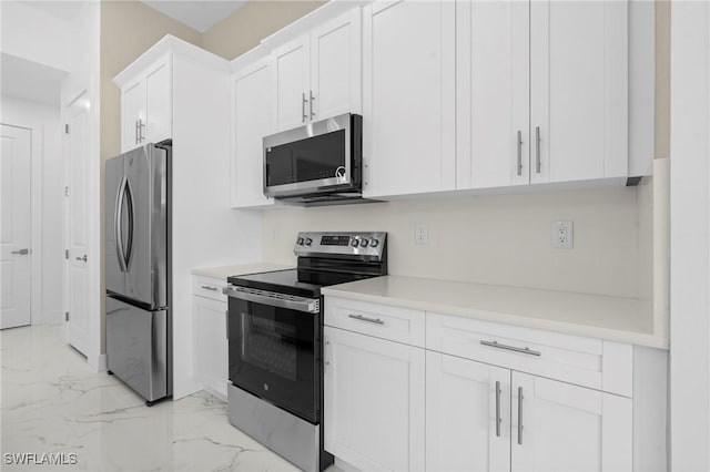 2705 68th St W, Lehigh Acres, FL 33971 - kitchen featuring marble finish floor, light countertops, appliances with stainless steel finishes, and white cabinetry