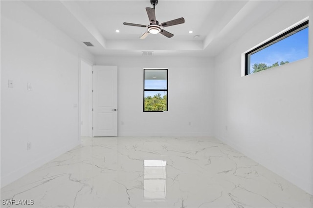 2705 68th St W, Lehigh Acres, FL 33971 - unfurnished room featuring ceiling fan, baseboards, visible vents, and a raised ceiling