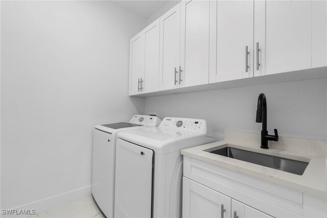 2705 68th St W, Lehigh Acres, FL 33971 - clothes washing area with separate washer and dryer, baseboards, cabinet space, and a sink
