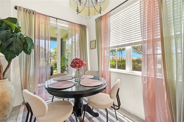 dining area with baseboards and an inviting chandelier